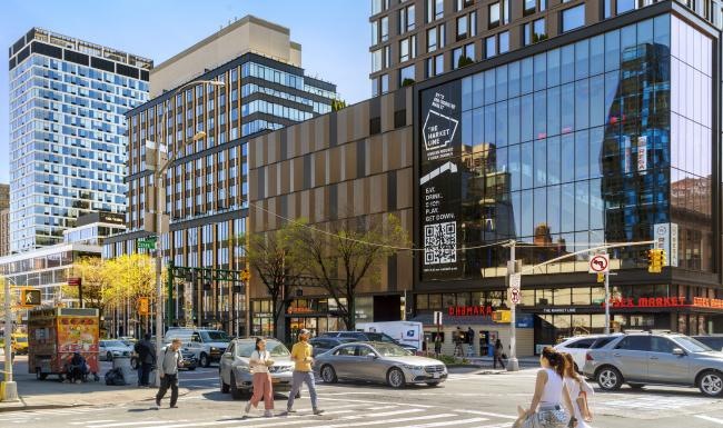 a street with cars and people on it and buildings around it