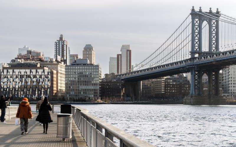 a bridge over a body of water with people walking on it